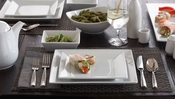An elegant dinner table setting featuring Kore Kitchen serving ware.