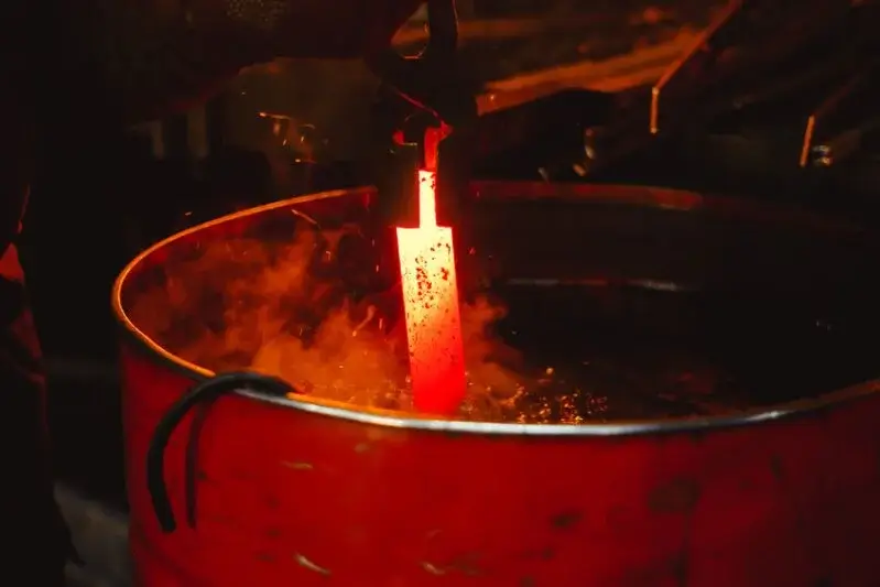 A hot piece of forged steel being quenched in oil.