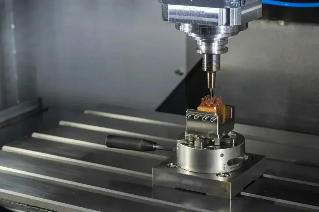 A CNC machine precisely milling a Kore Kitchen pan.