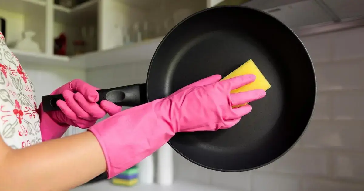 An artisan hand-polishing a pan.