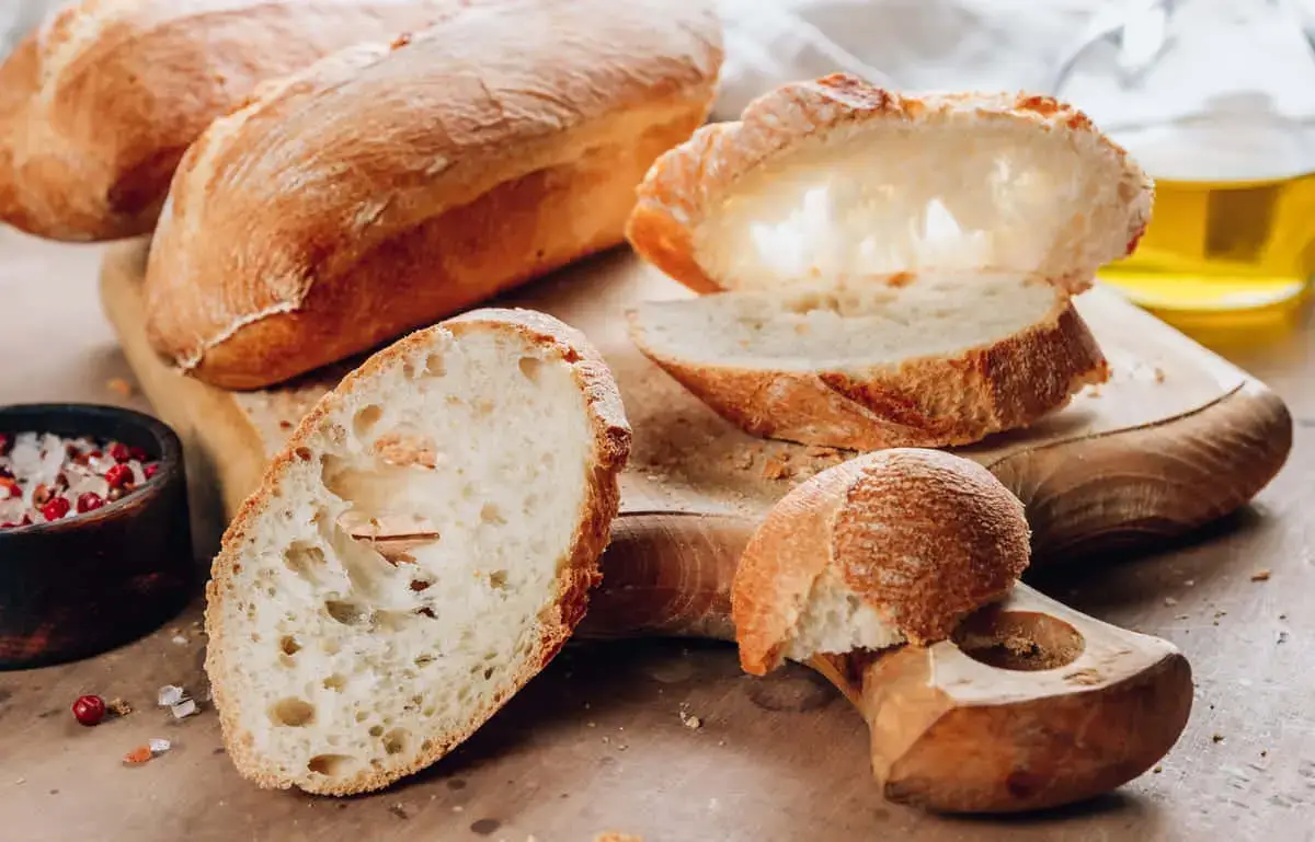 Artisanal bread loaves on a wooden table.