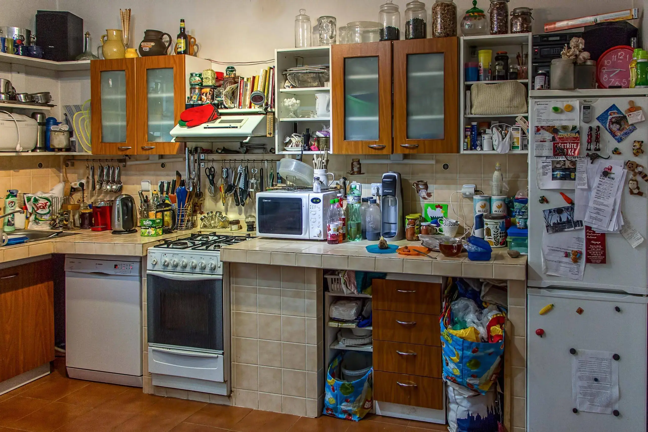 A cluttered and disorganized kitchen counter.